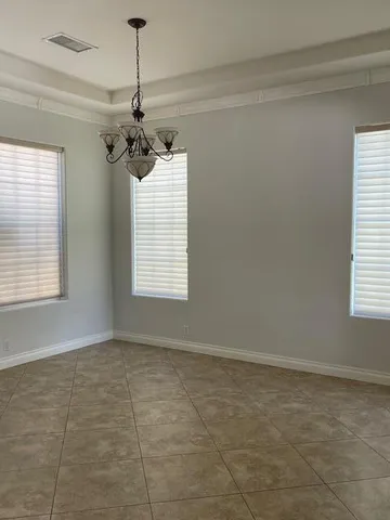 a view of a room with a windows and ceiling fan