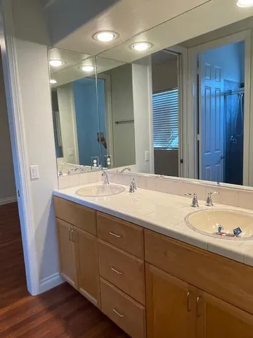 a bathroom with a tub sink and mirror