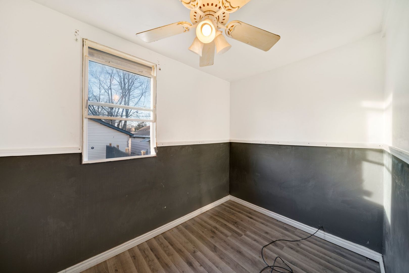 14446 Des Plaines Street Harvey, IL 60426 - Photo 11 of 19 a view of an empty room with wooden floor and a window