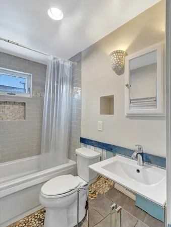 a bedroom with two beds and painting on the wall