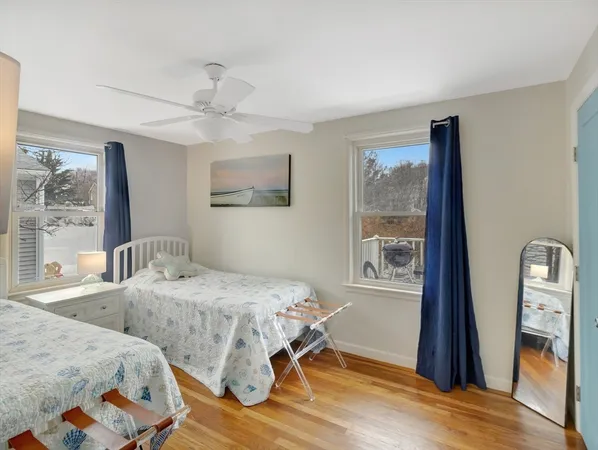 a bedroom with a bed and a lamp on the dresser
