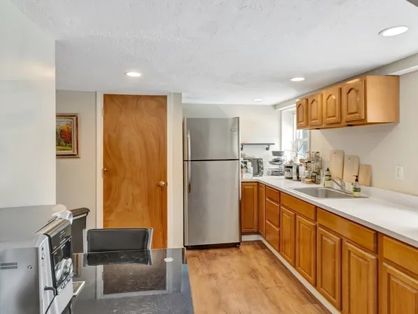 a kitchen with stainless steel appliances granite countertop a refrigerator and a sink