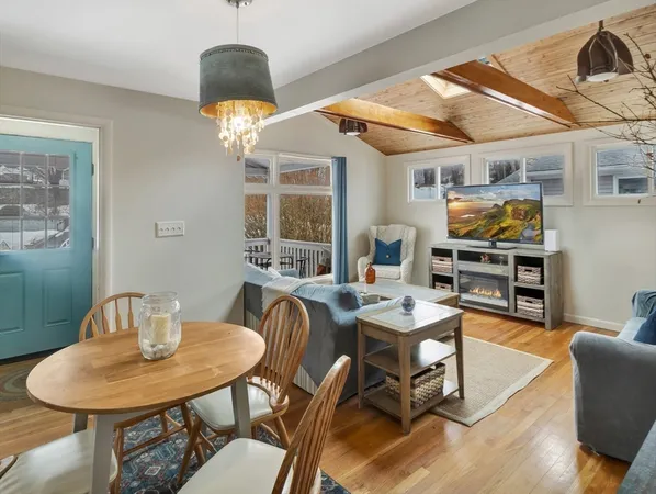 a dining room with furniture a rug and wooden floor