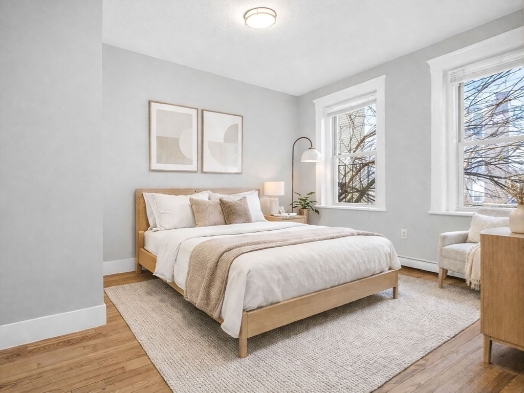 12 Ransom Road, Unit 7 Boston, MA 02135 - Photo 1 of 4 a bedroom with a bed lamp and window