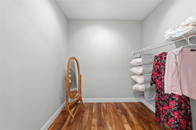 a living room with furniture kitchen view and a large window
