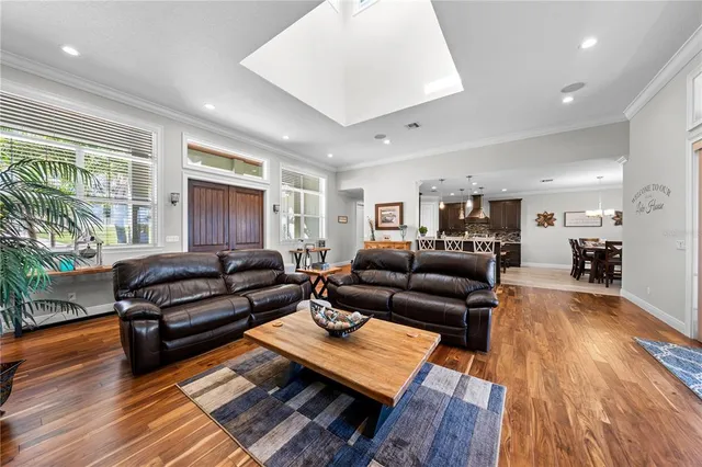 a large kitchen with granite countertop a stove top oven a sink a counter space and cabinets