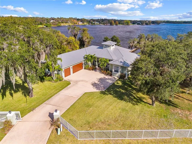 an aerial view of residential houses with outdoor space and ocean view