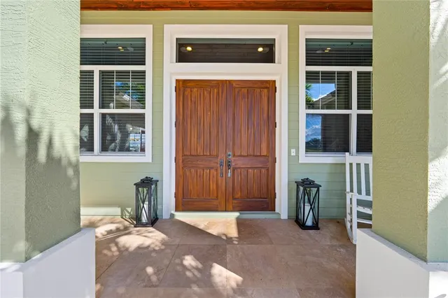 a living room with furniture kitchen view and a wooden floor