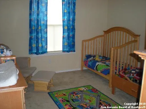 a bed sitting in a bedroom next to a window