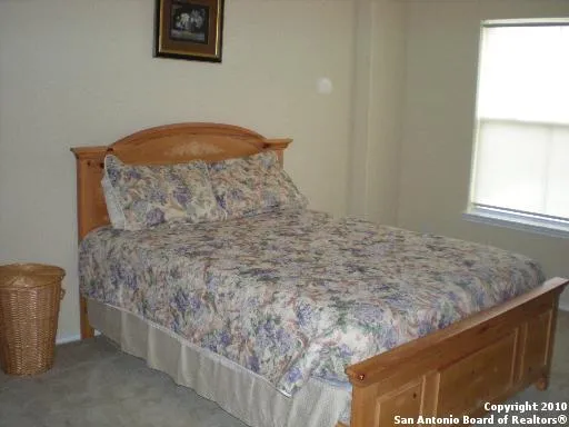 a bed sitting in a bathroom next to a window