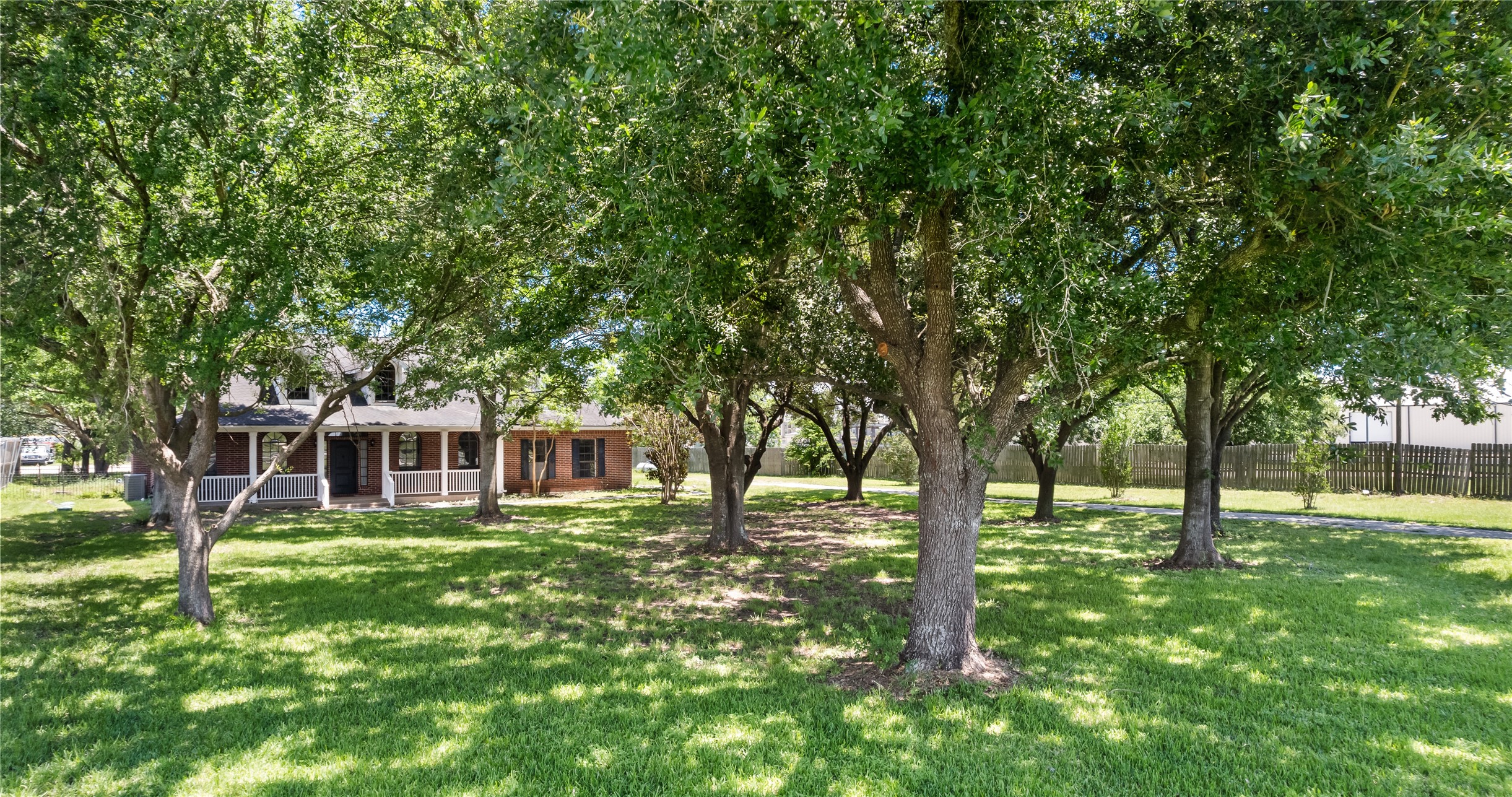 20240 Cypress Rosehill Road Tomball, TX 77377 - Photo 10 of 26 a house view with swimming pool and garden