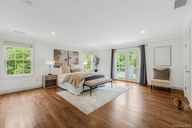 1 Kewanee Road New Rochelle, NY 10804 - Photo 26 of 36 a spacious bedroom with a large bed a chandelier and windows