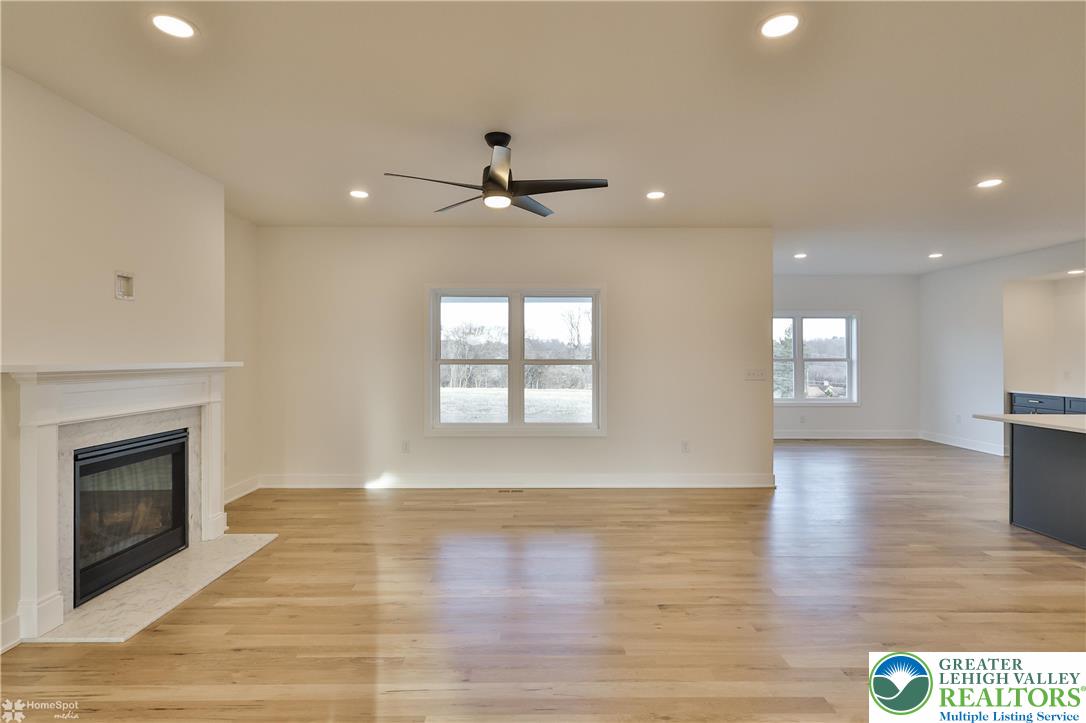 448 Long Lane Road Walnutport, PA 18088 - Photo 16 of 65 a view of an empty room with wooden floor fireplace and a window