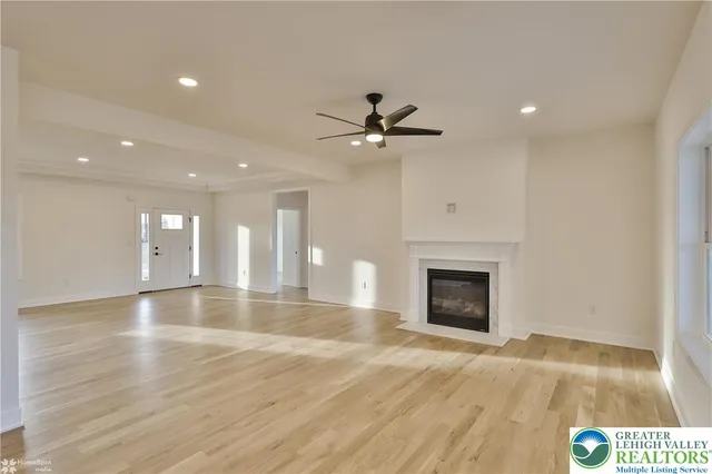 a large kitchen with stainless steel appliances a sink and cabinets