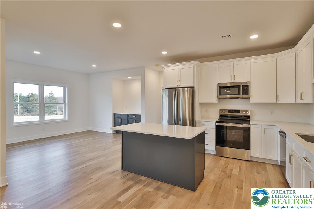 448 Long Lane Road Walnutport, PA 18088 - Photo 20 of 65 a kitchen with stainless steel appliances granite countertop a stove a sink and a refrigerator