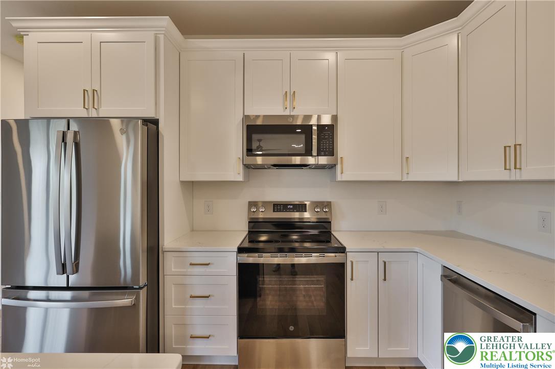448 Long Lane Road Walnutport, PA 18088 - Photo 26 of 65 a kitchen with appliances a refrigerator and cabinets