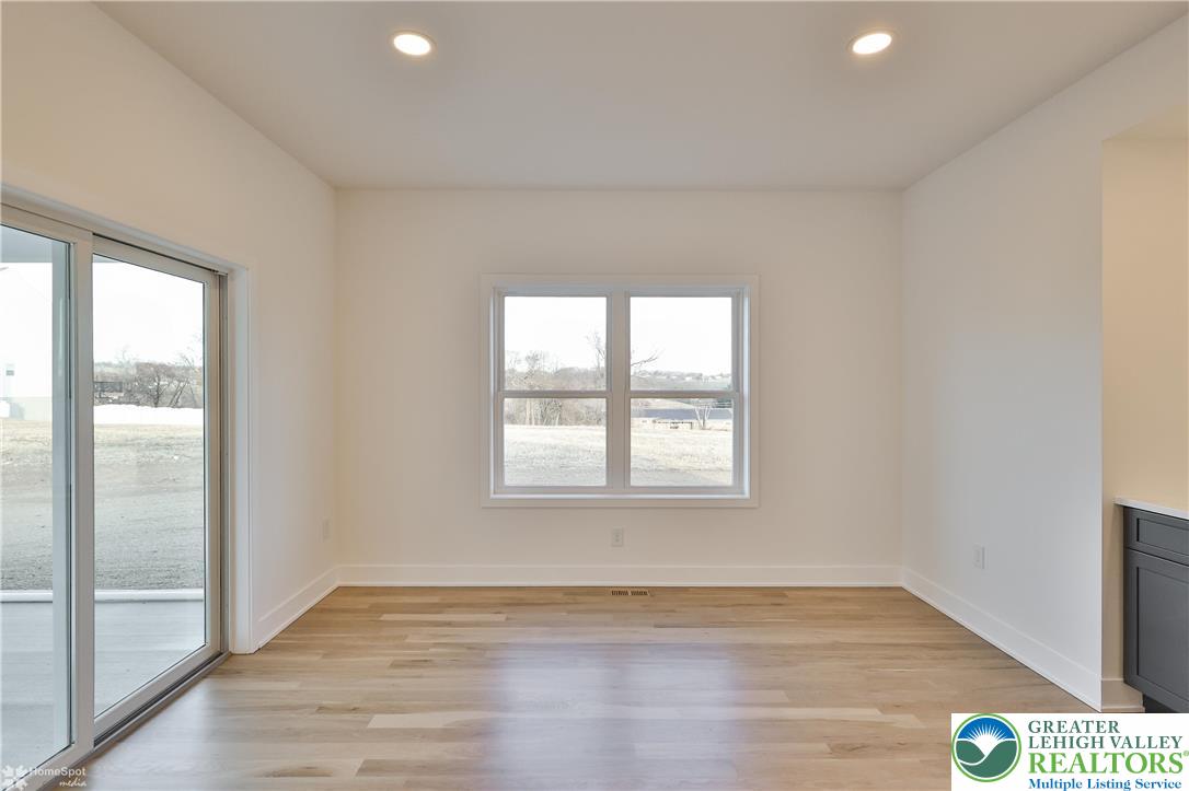 448 Long Lane Road Walnutport, PA 18088 - Photo 28 of 65 an empty room with wooden floor and windows