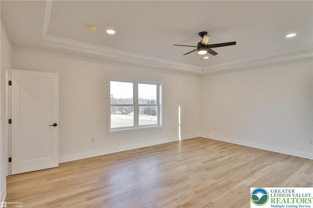 448 Long Lane Road Walnutport, PA 18088 - Photo 35 of 65 an empty room with wooden floor fan and windows