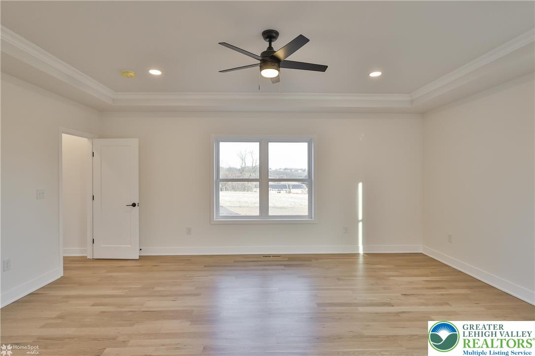 448 Long Lane Road Walnutport, PA 18088 - Photo 36 of 65 a view of an empty room with wooden floor and a ceiling fan