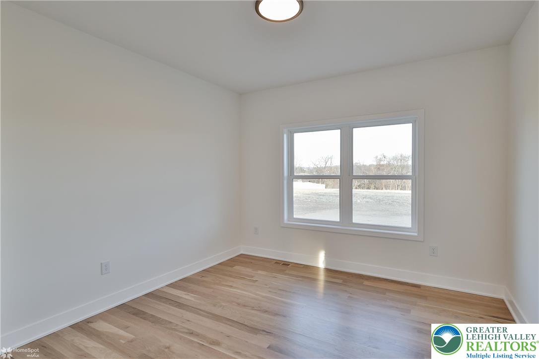 448 Long Lane Road Walnutport, PA 18088 - Photo 45 of 65 an empty room with wooden floor and windows