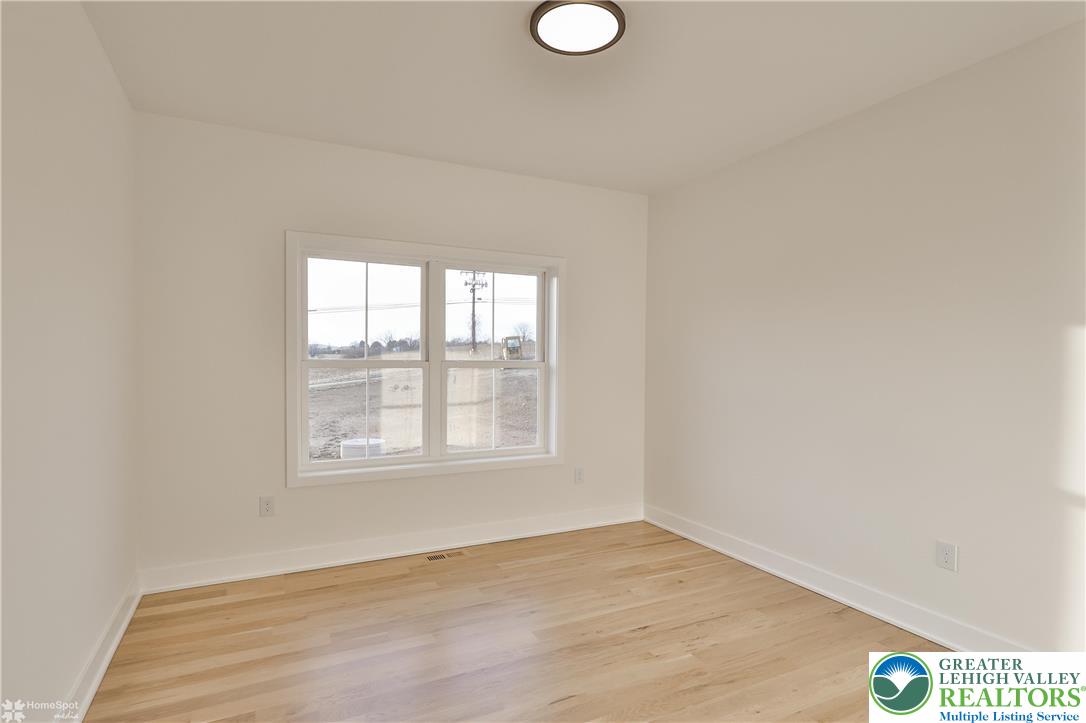 448 Long Lane Road Walnutport, PA 18088 - Photo 52 of 65 an empty room with wooden floor and windows