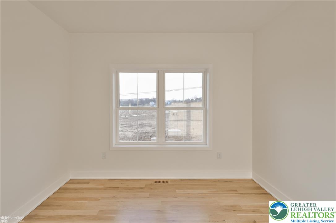 448 Long Lane Road Walnutport, PA 18088 - Photo 53 of 65 an empty room with wooden floor and windows