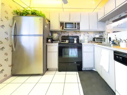 a kitchen with a refrigerator a stove top oven a sink and dishwasher