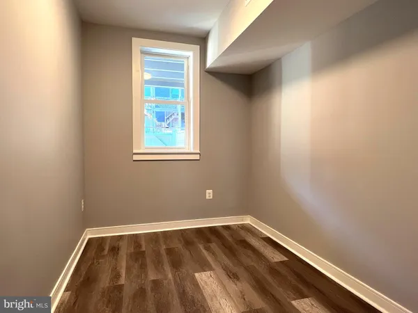 a view of a room with wooden floor and window
