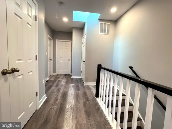 a view of hallway with wooden floor