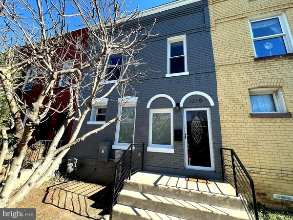 a view of a brick house with many windows