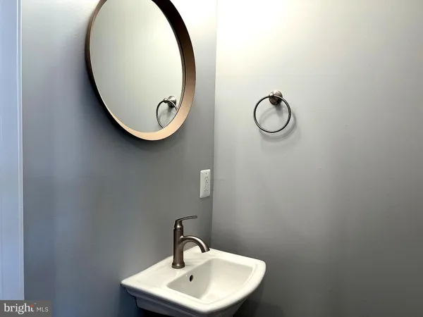 a bathroom with a sink and mirror