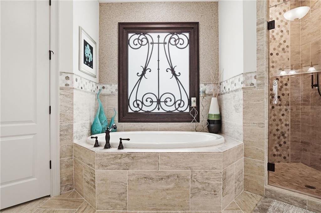 8340 Colonial Place Duluth, GA 30097 - Photo 28 of 74 a bathroom with a bathtub and shower