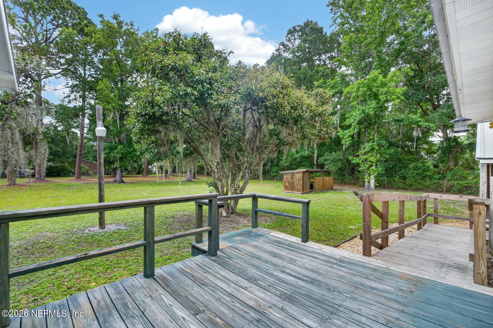 1950 Lightsey Road St. Augustine, FL 32084 - Photo 33 of 57 a view of a deck with chair and wooden fence