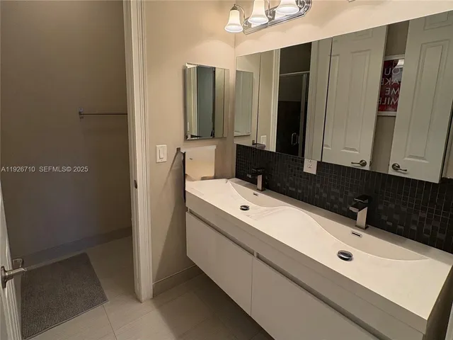 a bathroom with a double vanity sink and mirror