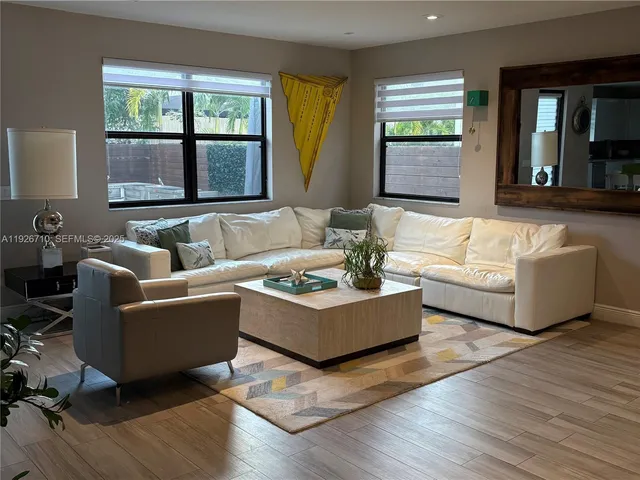 a living room with furniture and a large window