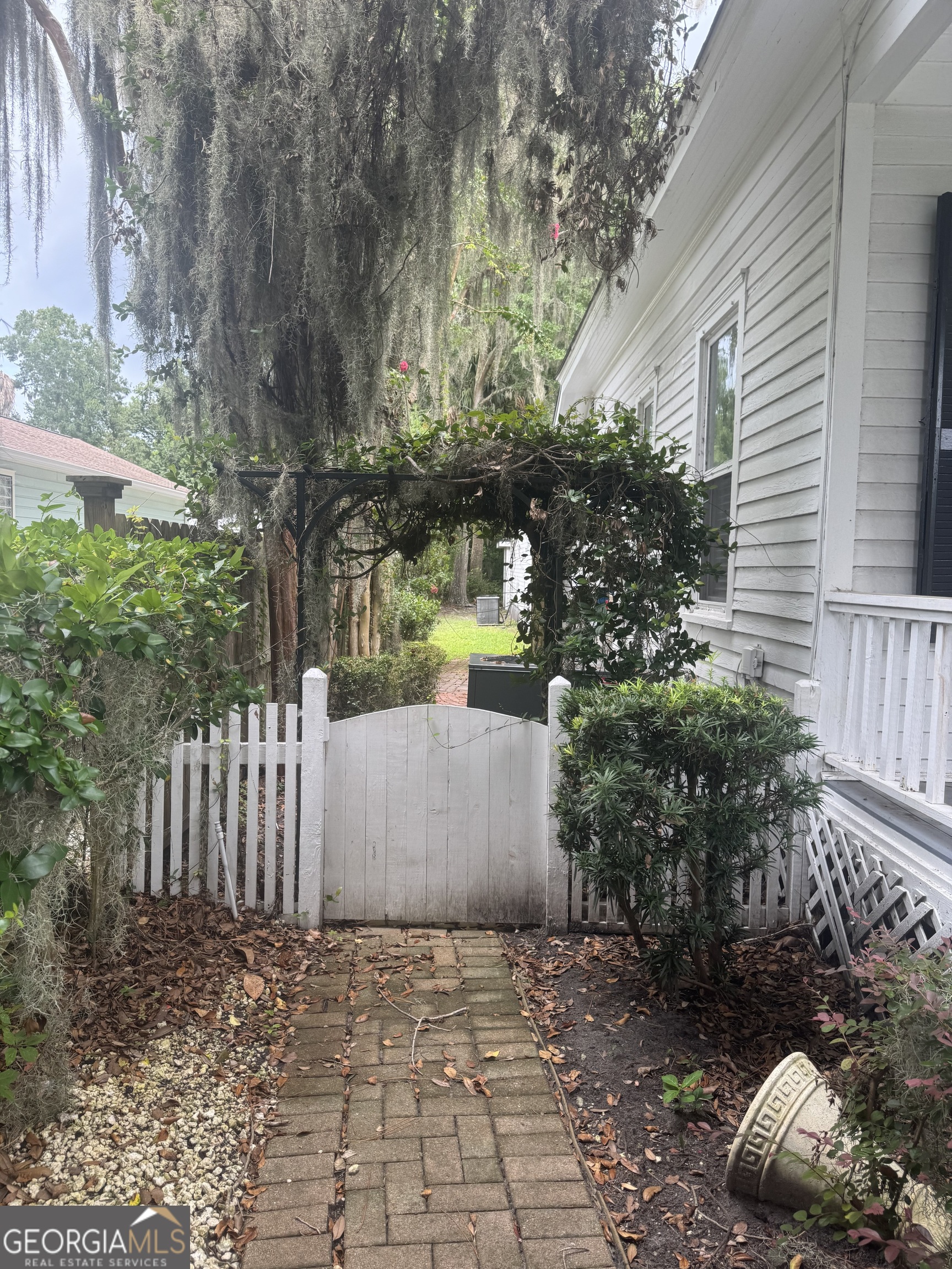 404 Ready Street St. Marys, GA 31558 - Photo 14 of 14 a view of a yard with plants and wooden fence