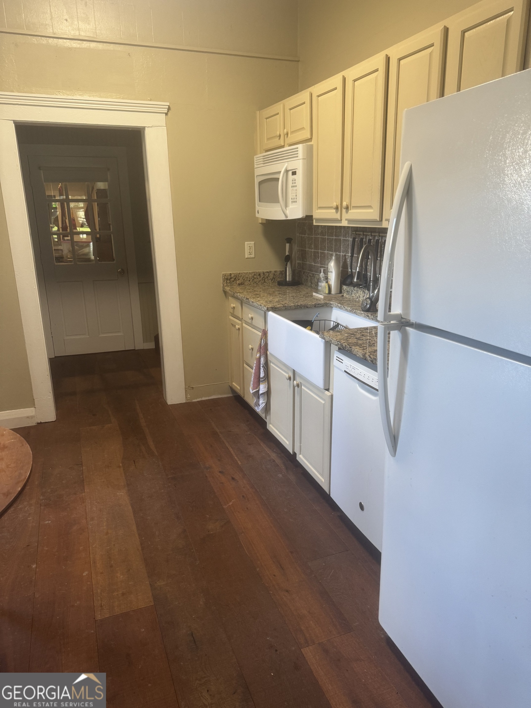 404 Ready Street St. Marys, GA 31558 - Photo 6 of 14 a kitchen with a refrigerator sink and cabinets