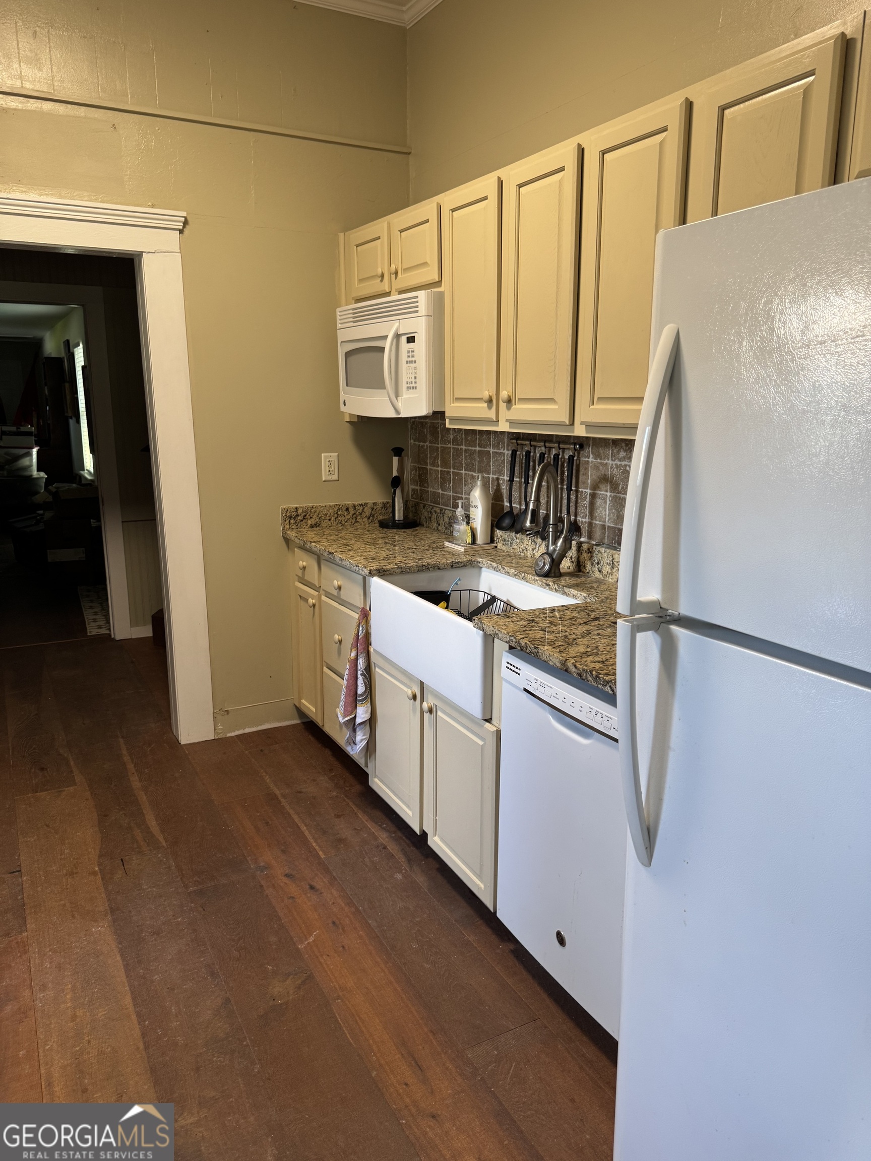 404 Ready Street St. Marys, GA 31558 - Photo 7 of 14 a kitchen with stainless steel appliances granite countertop a refrigerator a sink and white cabinets
