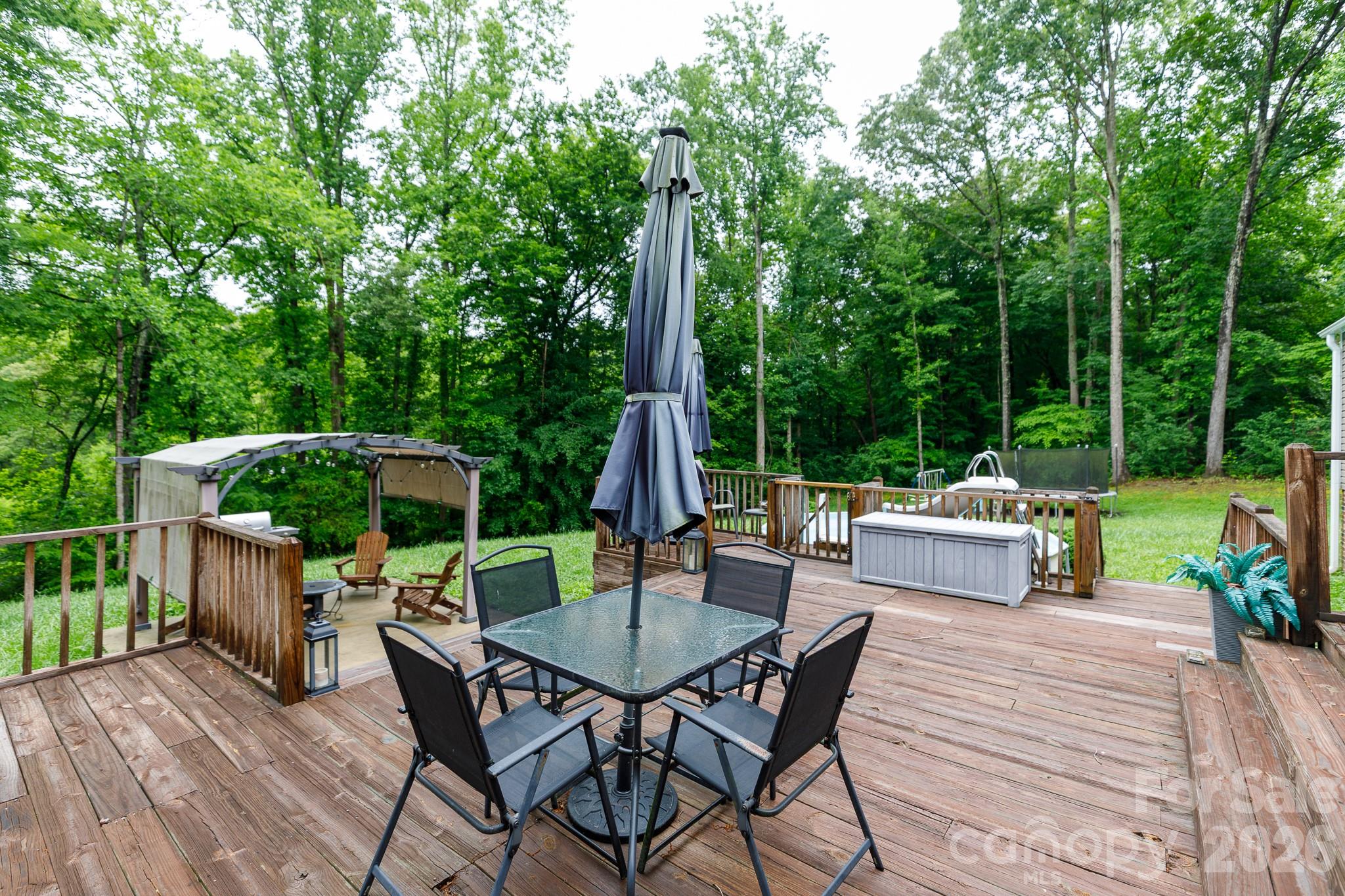 652 Sutton Spring Road York, SC 29745 - Photo 22 of 28 a view of table and chairs in patio with wooden fence