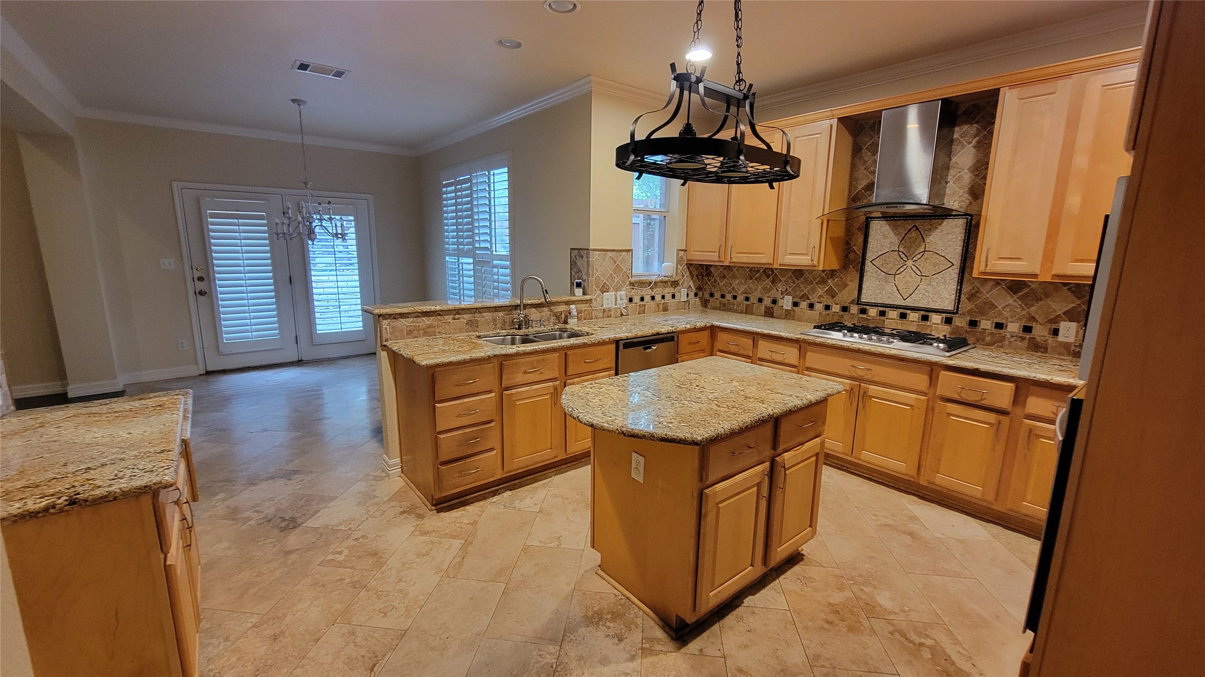 2832 Grimes Ranch Road Austin, TX 78732 - Photo 16 of 37 A gourmet kitchen offers rich wood cabinetry, granite countertops, and a striking mosaic tile backsplash.