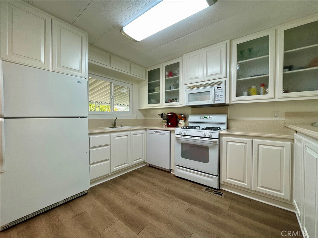 31130 South General Kearny Road, Unit 145 Temecula, CA 92591 - Photo 12 of 27 a kitchen with cabinets appliances and a window