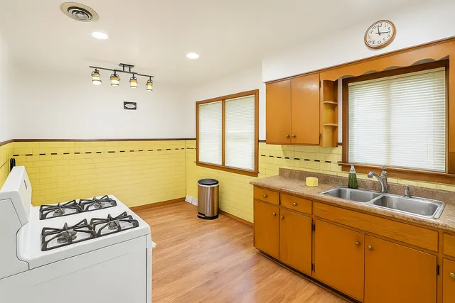 a kitchen with a stove a sink and a refrigerator
