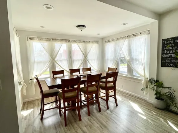 a view of a dining room with furniture window and wooden floor