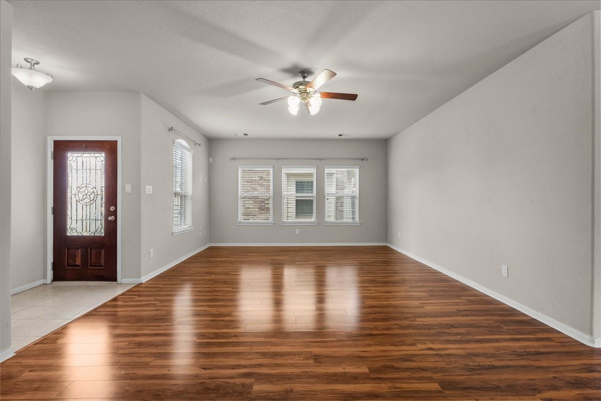 5111 Bay Lane Bacliff, TX 77518 - Photo 5 of 48 a view of an empty room with wooden floor and a window
