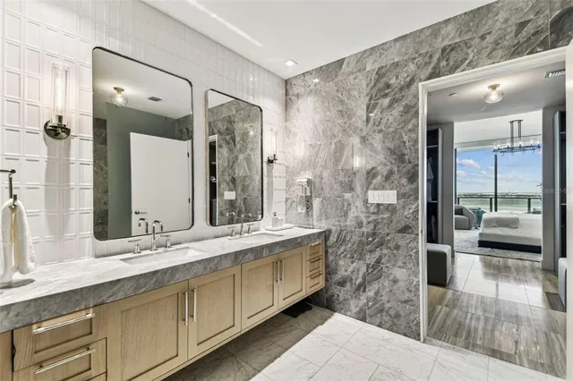 a bathroom with a bathtub sink and mirror
