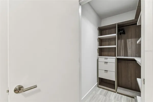 a bedroom with a bed and a night stand