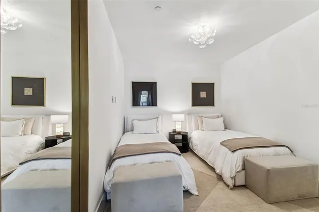 a view of a bedroom with furniture and wooden floor