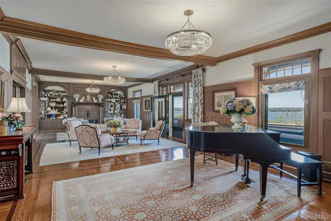 a living room with lots of furniture and a chandelier
