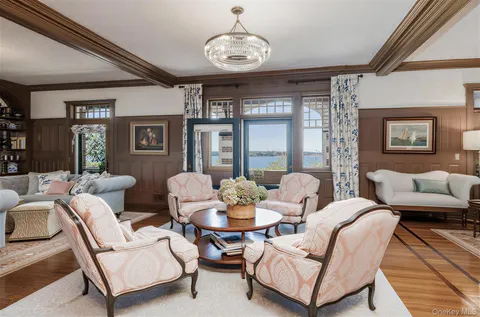 a living room with furniture wooden floor and a chandelier