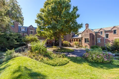 a front view of house with yard and green space